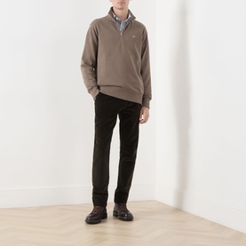 Model wearing Gant Faded Taupe quarter-zip sweatshirt, styled with grey shirt, dark trousers and brown lace-up boots.