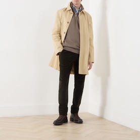 Model wearing Gant Faded Taupe sweatshirt, styled with a beige mac coat, dark trousers, and brown lace-up boots.