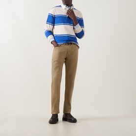 Model wearing Gant Nautical Blue striped cotton rugby sweatshirt, styled with tan chinos and black loafers.