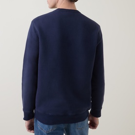 Model wearing Gant V-Stitch Logo Sweatshirt in navy, back view, with ribbed trims and straight hemline, styled with blue jeans.