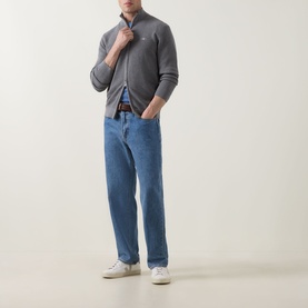 Model wearing Gant Shield Logo Zip Sweater in dark grey melange with blue jeans and white trainers.