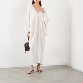 Model wearing The Frankie Shop Ivory viscose maxi dress with V-neck and batwing sleeves, styled with brown mini bag and strappy sandals