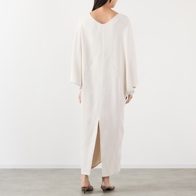 Model wearing The Frankie Shop ivory viscose maxi dress, shown from behind, featuring V-neck, batwing sleeves and back split hem.