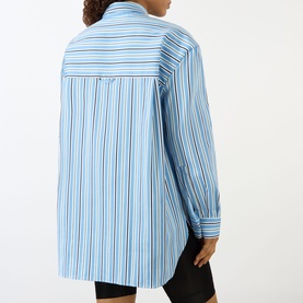 Model wearing The Frankie Shop Oana Padded Stripe Shirt in Blue Multi Stripe, back view, showing dropped shoulders and long sleeves