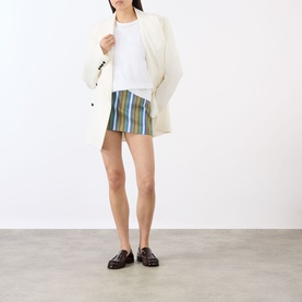 Model wearing The Frankie Shop Green Multi Stripe mini skirt, styled with a cream blazer, white tee, and dark brown loafers.