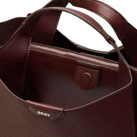 DKNY Willa Logo Satchel in Aged Wine, interior view showing zip pocket, magnetic snap fastening and silver-toned hardware detail