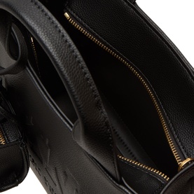 DKNY Hadlee Small Tote Bag in black with gold-tone zip, showing open interior with zip pocket and embossed logo lining.