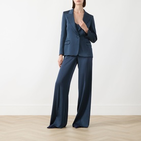 Model wearing steel blue satin-finish blazer and wide-leg trousers suit set with single-button fastening