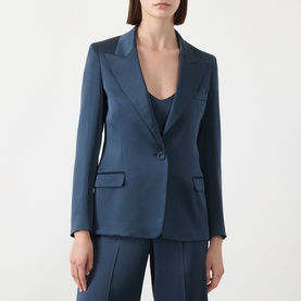 Model wearing teal blue single-button blazer with notch lapels and flap pockets, styled with matching trousers and cami top.