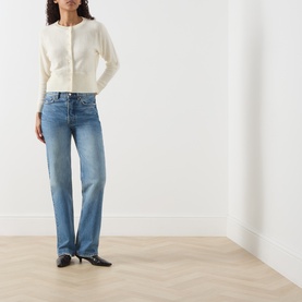 Model wearing Marella Manto Knitted Cardigan in cream wool-cashmere blend, styled with blue wide-leg jeans and black kitten heel mules.