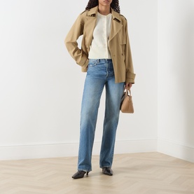 Model wearing Marella Manto Cream Knitted Cardigan, styled with a beige trench jacket, blue straight-leg jeans and black heeled mules.