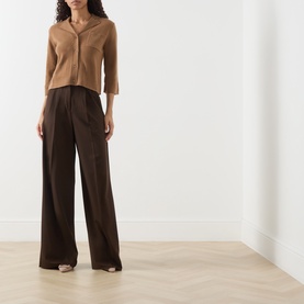 Model wearing Marella Alpaca Knitted Polo Cardigan in camel with wide-leg dark brown trousers and nude heeled sandals.