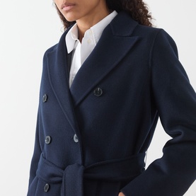 Model wearing Marella Laghi Belted Navy Coat, double-breasted with peak lapel, styled with a white shirt underneath