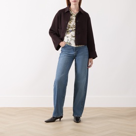 Model wearing Marella brown wool blend jacket with printed top, wide-leg blue jeans and black heeled mules.