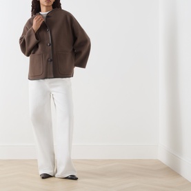 Model wearing Marella brown wool blend coat with button front and patch pockets, styled with white wide-leg trousers