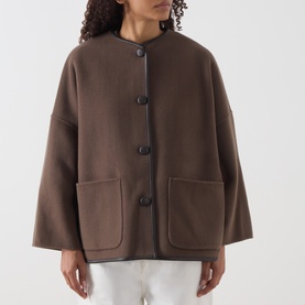 Model wearing Marella brown wool blend coat with collarless neckline, large patch pockets and oversized silhouette