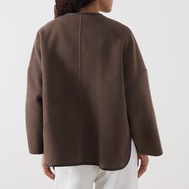 Model wearing Marella brown wool blend coat, rear view, relaxed fit with dropped shoulders, styled with white trousers