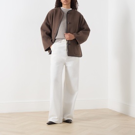 Model wearing Marella brown wool blend coat with collarless design, styled with grey top and white wide-leg trousers