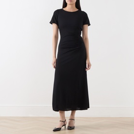 Model wearing Marella black midi dress with short sleeves, ruched waist detail and flared skirt, styled with black heeled mules.