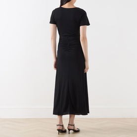 Model wearing Marella black midi dress, back view, short sleeves, ruched waist detail, with black heeled sandals