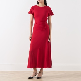 Model wearing Marella red midi dress with flutter sleeves, ruched waist detail and flared skirt, styled with black heeled mules.