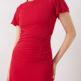 Model wearing Marella red short-sleeve mini dress with ruched front detail and flutter sleeves in stretch viscose blend fabric.