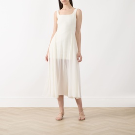 Model wearing Marella Sabine Georgette Dress in Wool White; sleeveless, square neckline, semi-sheer midi skirt, styled with strappy flat sandals.