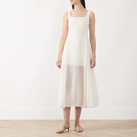 Model wearing Marella Sabine Georgette Dress in Wool White; sleeveless square neck midi with semi-sheer fit-and-flare skirt, styled with nude mule