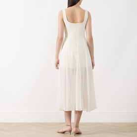 Model wearing Marella Sabine Georgette Dress in Wool White; sleeveless fit-and-flare midi with semi-sheer skirt, styled with nude flat sandals