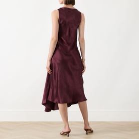 Model wearing Marella Libero Draped Dress in Bordeaux, sleeveless satin midi with asymmetric hemline, shown from behind with mule heels