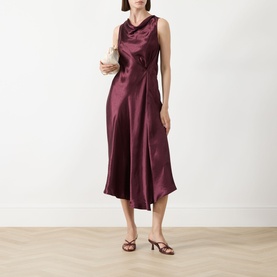 Model wearing Marella Libero Draped Dress in Bordeaux, sleeveless satin midi with asymmetric hem, styled with strappy heels and clutch bag.