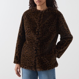 Model wearing Marella cocoa spotted faux fur jacket with leopard print, styled with blue jeans.