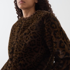 Model wearing Marella cocoa spotted leopard-print textured jacket, cropped close-up showing fluffy polyester fabric detail.