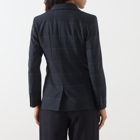 Model wearing Marella navy check blazer jacket, rear view, styled with matching navy wide-leg trousers.