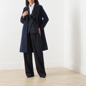 Model wearing Marella navy check jacket, styled with a white shirt, matching navy blazer, and wide-leg black trousers.