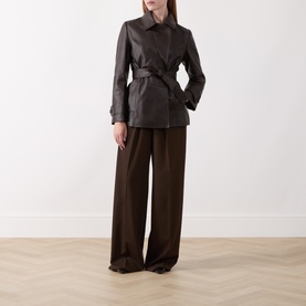 Model wearing Marella brown leather belted jacket with wide-leg brown trousers.