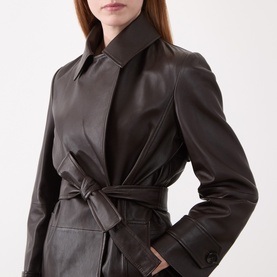 Model wearing Marella brown leather belted jacket with wide lapels and tied waist belt, close-up detail view.