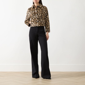 Model wearing Marella Angel Leopard Faux Fur Jacket in camel spotted with black wide-leg trousers