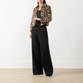 Model wearing Marella Angel Leopard Faux Fur Jacket in camel spotted, styled with black wide-leg trousers and black top.