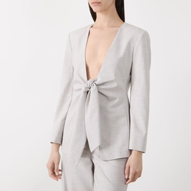 Model wearing Marella Facella Tie-Front Blazer in light grey with deep V-neckline, tie-front detail and structured shoulders, styled with matching