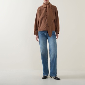 Model wearing Marella Calamo Water-Repellent Jacket in Tobacco Brown with tied front sash, styled with blue straight-leg jeans and black mules.
