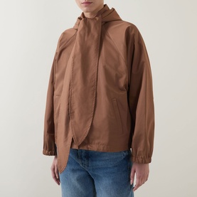 Model wearing Marella Calamo Water-Repellent Jacket in Tobacco Brown with detachable hood, styled with blue jeans.