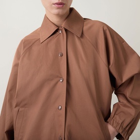 Model wearing Marella Calamo Water-Repellent Jacket in Tobacco Brown, showing shirt collar, snap buttons, and raglan sleeve detail.
