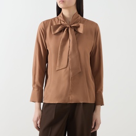 Model wearing Marella Kabala Silk Tie Front Blouse in Tobacco Brown with stand collar and bow tie detail, styled with dark brown wide-leg trousers.