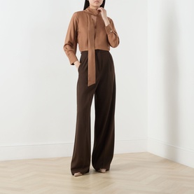Model wearing Marella Kabala Silk Tie Front Blouse in Tobacco Brown with stand collar, styled with dark brown wide-leg trousers.