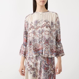 Model wearing Marella Girino Printed Blouse in cream, featuring paisley print, collarless neckline, flared cuffs, styled with matching wide-leg