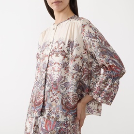 Model wearing Marella Girino Printed Blouse in cream with paisley print, collarless neckline, flared cuffs, and matching trousers.
