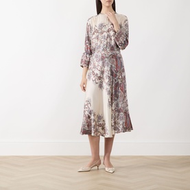 Model wearing Marella Decano Printed Skirt in cream, flared midi satin finish with floral print, styled with matching top and white heels.