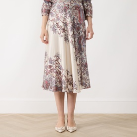 Model wearing Marella Decano Printed Skirt in cream, midi-length flared satin finish with paisley floral print, styled with matching top and nude