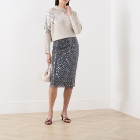 Model wearing Marella medium grey sequin midi pencil skirt, styled with cream embellished jumper, white bag and burgundy heeled sandals.